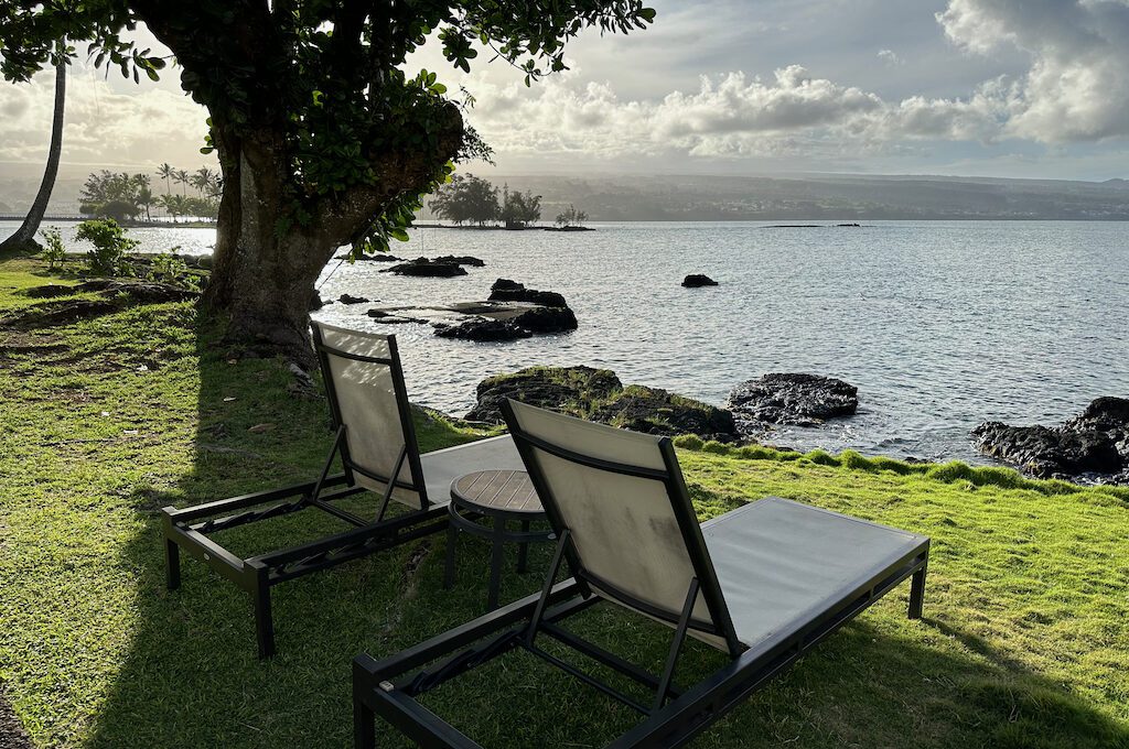 Two lounge chairs overlooking the ocean at Hilton DoubleTree Hilo